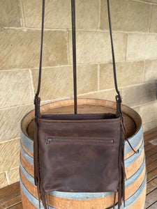 RUSTIC BLOOM CROSSBODY FRINGE BAG with unique floral carving